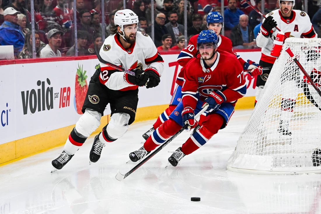 Sep 27, 2023; Montreal, Quebec, CAN; Montreal Canadiens center Kirby Dach (77) defends the puck against Ottawa Senators left wing Jiri Smejkal (13) during the second period at Bell Centre. Mandatory Credit: David Kirouac-USA TODAY Sports