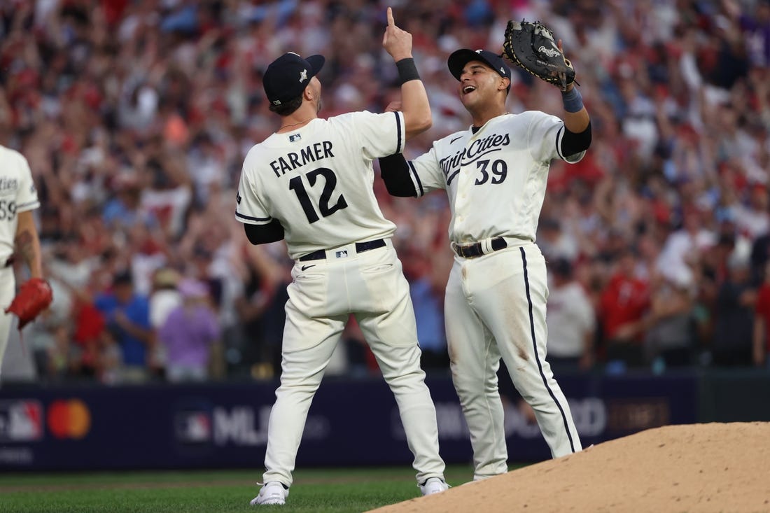 Oct 3, 2023; Minneapolis, Minnesota, USA; Minnesota Twins third baseman Kyle Farmer (12) and first baseman Donovan Solano (39) celebrated after defeating Toronto Blue Jays  during game one of the Wildcard series for the 2023 MLB playoffs at Target Field. Mandatory Credit: Jesse Johnson-USA TODAY Sports