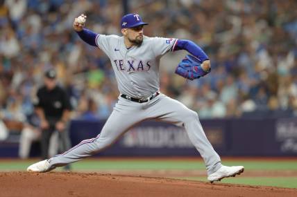 Oct 4, 2023; St. Petersburg, Florida, USA; Texas Rangers starting pitcher Nathan Eovaldi (17) pitches against the Tampa Bay Rays in the first inning during game two of the Wildcard series for the 2023 MLB playoffs at Tropicana Field. Mandatory Credit: Nathan Ray Seebeck-USA TODAY Sports