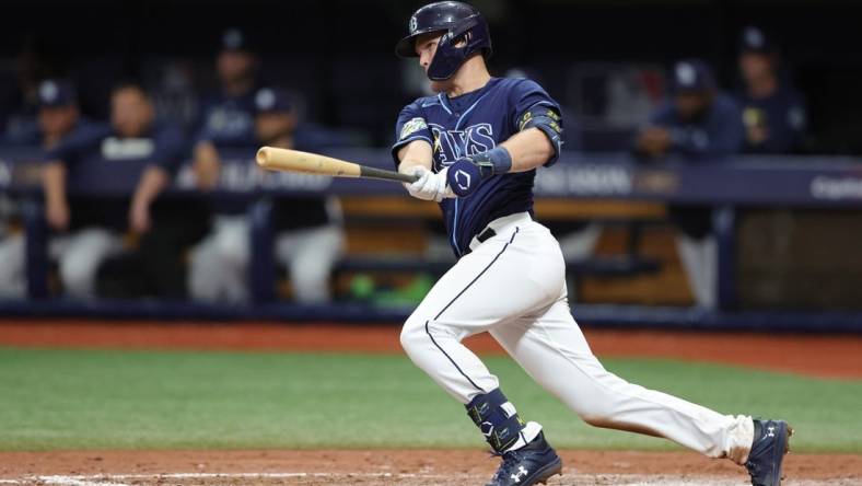 Oct 4, 2023; St. Petersburg, Florida, USA; Tampa Bay Rays second baseman Curtis Mead (25) hits an RBI single against the Texas Rangers in the seventh inning during game two of the Wildcard series for the 2023 MLB playoffs at Tropicana Field. Mandatory Credit: Nathan Ray Seebeck-USA TODAY Sports