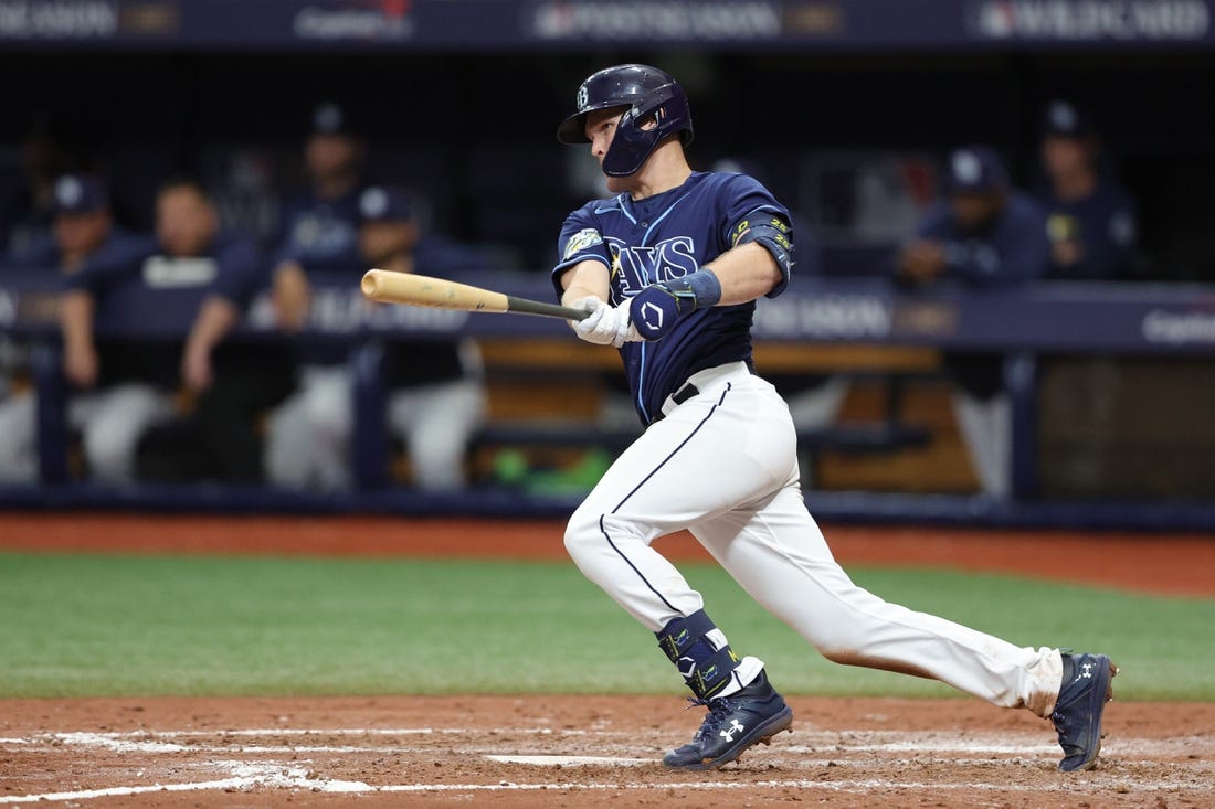 Oct 4, 2023; St. Petersburg, Florida, USA; Tampa Bay Rays second baseman Curtis Mead (25) hits an RBI single against the Texas Rangers in the seventh inning during game two of the Wildcard series for the 2023 MLB playoffs at Tropicana Field. Mandatory Credit: Nathan Ray Seebeck-USA TODAY Sports