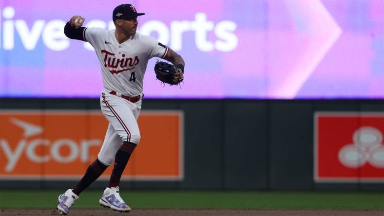 Oct 4, 2023; Minneapolis, Minnesota, USA; Minnesota Twins shortstop Carlos Correa (4) throws to first for an out in the eighth inning against the Toronto Blue Jays during game two of the Wildcard series for the 2023 MLB playoffs at Target Field. Mandatory Credit: Jesse Johnson-USA TODAY Sports