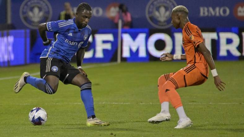 Oct 4, 2023; Montreal, Quebec, CAN; CF Montreal defender Zachary Brault-Guillard (15) dribbles against Houston Dynamo forward Nelson Quinones (21) during the first half at Stade Saputo. Mandatory Credit: Eric Bolte-USA TODAY Sports