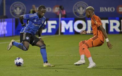 Oct 4, 2023; Montreal, Quebec, CAN; CF Montreal defender Zachary Brault-Guillard (15) dribbles against Houston Dynamo forward Nelson Quinones (21) during the first half at Stade Saputo. Mandatory Credit: Eric Bolte-USA TODAY Sports