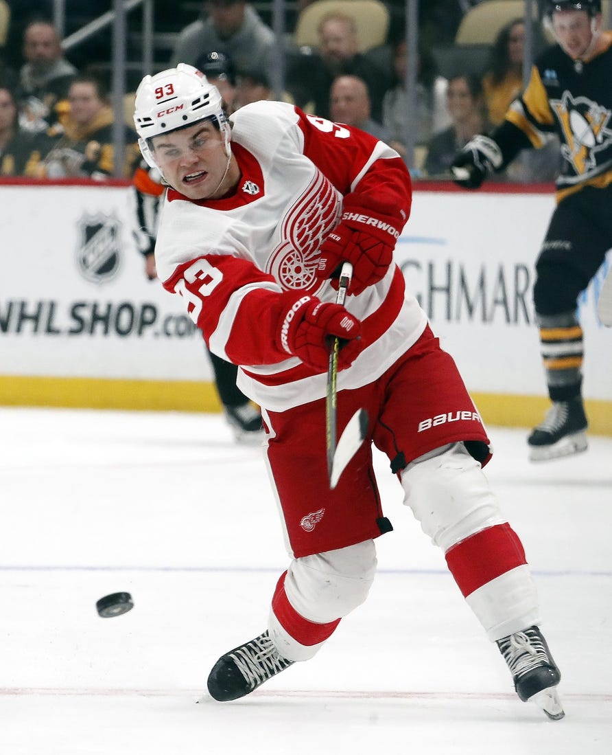 Oct 4, 2023; Pittsburgh, Pennsylvania, USA; Detroit Red Wings Detroit Red Wings right wing Alex DeBrincat (93) takes a slap shot against the Pittsburgh Penguins during the second period at PPG Paints Arena. Mandatory Credit: Charles LeClaire-USA TODAY Sports