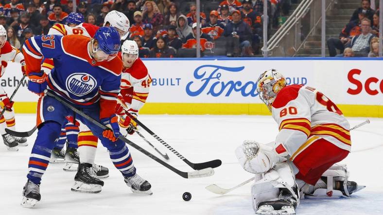 Oct 4, 2023; Edmonton, Alberta, CAN; Edmonton Oilers forward Warren Foegele (37) tries to get a shot away on Calgary Flames goaltender Dan Vladar (80) during the third period at Rogers Place. Mandatory Credit: Perry Nelson-USA TODAY Sports