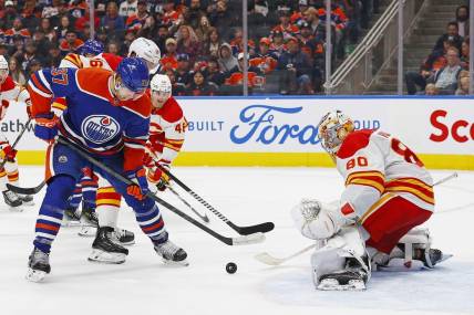 Oct 4, 2023; Edmonton, Alberta, CAN; Edmonton Oilers forward Warren Foegele (37) tries to get a shot away on Calgary Flames goaltender Dan Vladar (80) during the third period at Rogers Place. Mandatory Credit: Perry Nelson-USA TODAY Sports