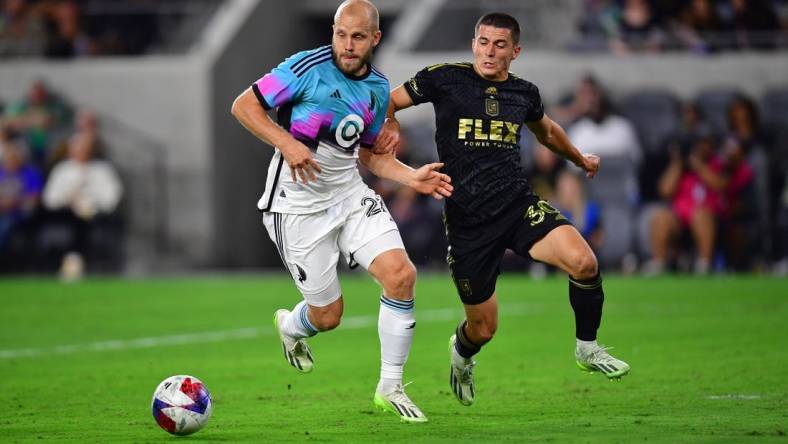 Oct 4, 2023; Los Angeles, California, USA; Los Angeles FC defender Sergi Palencia (30) plays for the ball against Minnesota United forward Teemu Pukki (22) during the first half at BMO Stadium. Mandatory Credit: Gary A. Vasquez-USA TODAY Sports