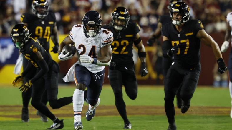 Oct 5, 2023; Landover, Maryland, USA; Chicago Bears running back Khalil Herbert (24) carries the ball as Washington Commanders linebacker Cody Barton (57) chases during the first quarter at FedExField. Mandatory Credit: Geoff Burke-USA TODAY Sports