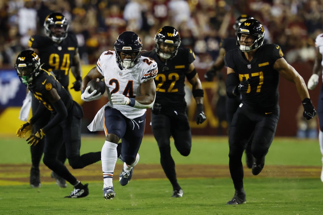 Oct 5, 2023; Landover, Maryland, USA; Chicago Bears running back Khalil Herbert (24) carries the ball as Washington Commanders linebacker Cody Barton (57) chases during the first quarter at FedExField. Mandatory Credit: Geoff Burke-USA TODAY Sports