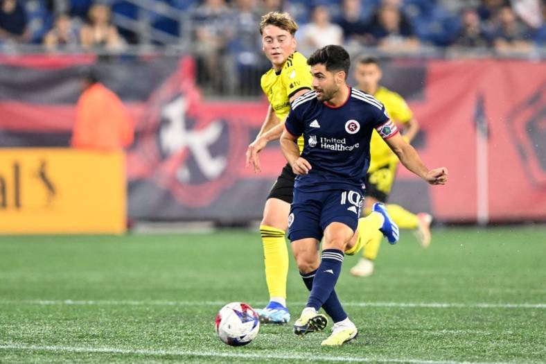 Oct 4, 2023; Foxborough, Massachusetts, USA; New England Revolution midfielder Carles Gil (10) passes the ball against the Columbus Crew during the first half at Gillette Stadium. Mandatory Credit: Brian Fluharty-USA TODAY Sports