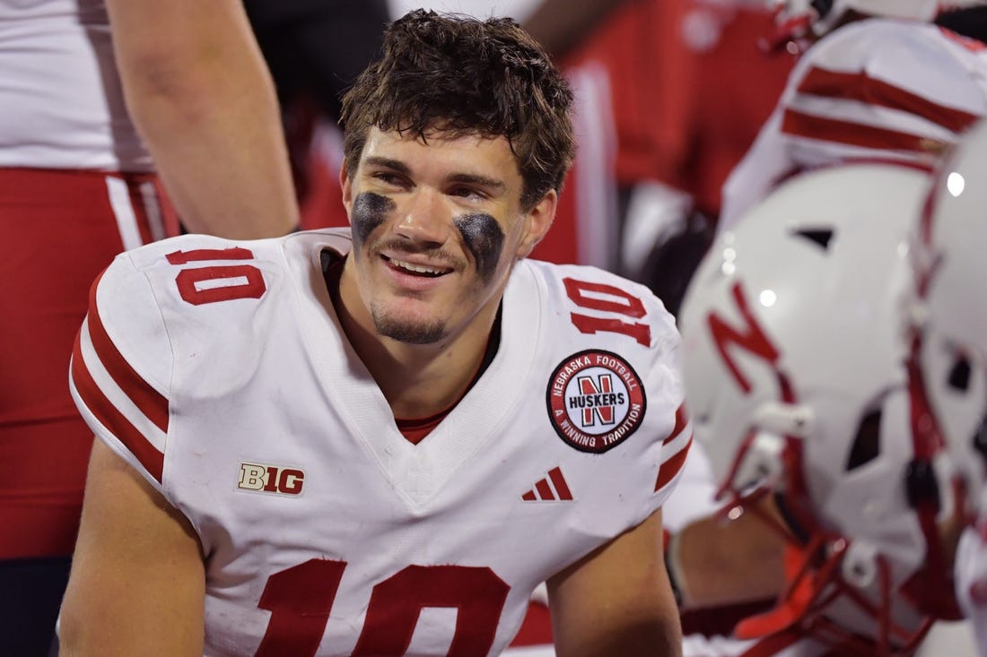 Oct 6, 2023; Champaign, Illinois, USA; Nebraska Cornhuskers quarterback Heinrich Haarberg (10) smiles with teammates on the bench during the second half against the Illinois Fighting Illini at Memorial Stadium. Mandatory Credit: Ron Johnson-USA TODAY Sports