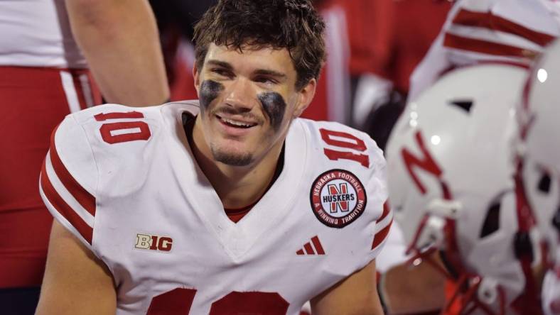 Oct 6, 2023; Champaign, Illinois, USA; Nebraska Cornhuskers quarterback Heinrich Haarberg (10) smiles with teammates on the bench during the second half against the Illinois Fighting Illini at Memorial Stadium. Mandatory Credit: Ron Johnson-USA TODAY Sports