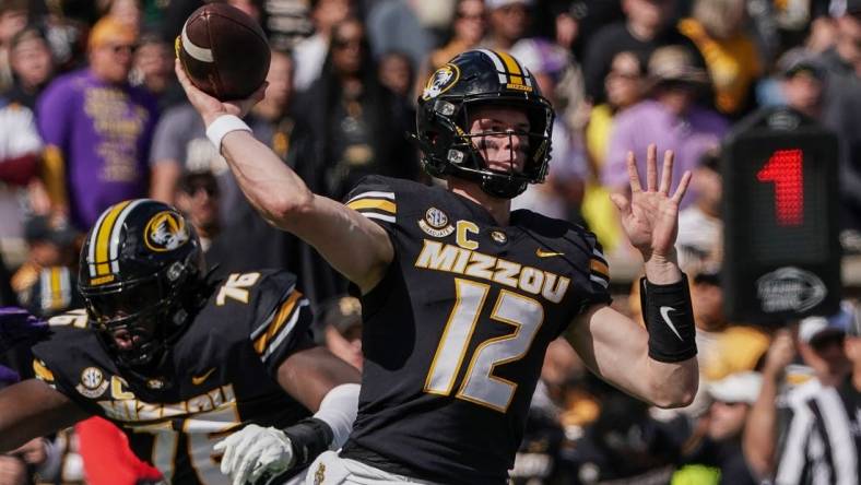 Oct 7, 2023; Columbia, Missouri, USA; Missouri Tigers quarterback Brady Cook (12) throws a pass against the LSU Tigers during the first half at Faurot Field at Memorial Stadium. Mandatory Credit: Denny Medley-USA TODAY Sports