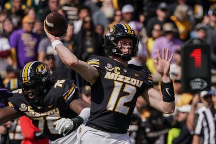 Oct 7, 2023; Columbia, Missouri, USA; Missouri Tigers quarterback Brady Cook (12) throws a pass against the LSU Tigers during the first half at Faurot Field at Memorial Stadium. Mandatory Credit: Denny Medley-USA TODAY Sports