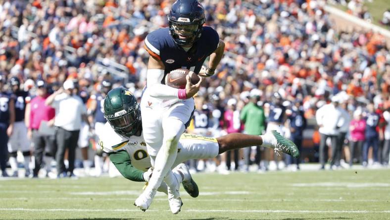 Oct 7, 2023; Charlottesville, Virginia, USA; Virginia Cavaliers quarterback Tony Muskett (11) scores a touchdown past William & Mary Tribe defensive lineman Nate Lynn (99) during the first half at Scott Stadium. Mandatory Credit: Amber Searls-USA TODAY Sports