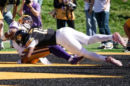 Oct 7, 2023; Columbia, Missouri, USA; LSU Tigers quarterback Jayden Daniels (5) scores a touchdown as Missouri Tigers defensive back Daylan Carnell (13) makes the tackle during the second half at Faurot Field at Memorial Stadium. Mandatory Credit: Denny Medley-USA TODAY Sports