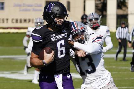 Oct 7, 2023; Evanston, Illinois, USA; Northwestern Wildcats quarterback Brendan Sullivan (6) runs for a touchdown as Howard Bison defensive back Jabari Knighten (13) defends him during the first half at Ryan Field. Mandatory Credit: David Banks-USA TODAY Sports