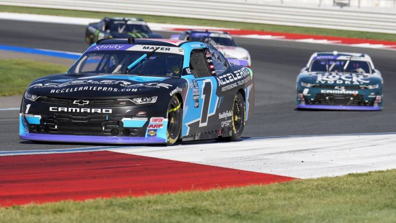 Oct 7, 2023; Concord, North Carolina, USA; NASCAR Xfinity Series driver Sam Mayer (1) leads driver Josh Berry (8) out of turn five during the Drive for the Cure 250 at Charlotte Motor Speedway Road Course. Mandatory Credit: Jim Dedmon-USA TODAY Sports