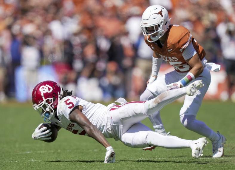 Oct 7, 2023; Dallas, Texas, USA; Oklahoma Sooners wide receiver Andrel Anthony (5) fights for yardage against the Texas Longhorns at the Cotton Bowl. This game makes up the 119th rivalry match up. Mandatory Credit: Ricardo B. Brazziell-USA TODAY Sports