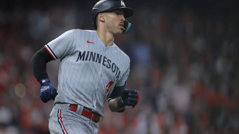 Oct 7, 2023; Houston, Texas, USA; Minnesota Twins shortstop Carlos Correa (4) hits a double in the eighth inning against the Houston Astros during game one of the ALDS for the 2023 MLB playoffs at Minute Maid Park. Mandatory Credit: Erik Williams-USA TODAY Sports