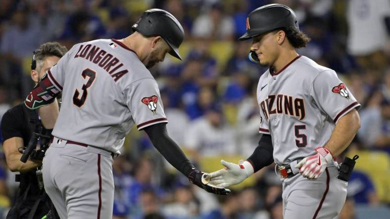 Oct 7, 2023; Los Angeles, California, USA; Arizona Diamondbacks center fielder Alek Thomas (5) reacts after hitting a home run against the Los Angeles Dodgers during the seventh inning for game one of the NLDS for the 2023 MLB playoffs at Dodger Stadium. Mandatory Credit: Jayne Kamin-Oncea-USA TODAY Sports