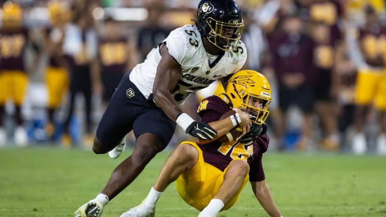 Oct 7, 2023; Tempe, Arizona, USA; Arizona State Sun Devils quarterback Trenton Bourguet (16) is sacked by Colorado Buffaloes defensive end Arden Walker (53) in the second half at Mountain America Stadium. Mandatory Credit: Mark J. Rebilas-USA TODAY Sports