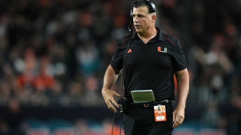 Oct 7, 2023; Miami Gardens, Florida, USA; Miami Hurricanes head coach Mario Cristobal walks on the field in the second half against the Georgia Tech Yellow Jackets at Hard Rock Stadium. Mandatory Credit: Jasen Vinlove-USA TODAY Sports