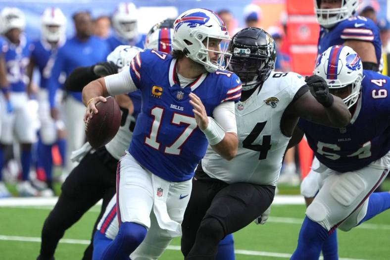 Oct 8, 2023; London United Kingdom, Buffalo Bills quarterback Josh Allen (17)] throws the ball under pressure from Jacksonville Jaguars defensive tackle Folorunso Fatukasi (94) during the first half of an NFL International Series game at Tottenham Hotspur Stadium. Mandatory Credit: Kirby Lee-USA TODAY Sports