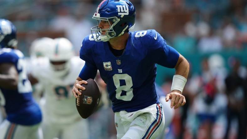 Oct 8, 2023; Miami Gardens, Florida, USA; New York Giants quarterback Daniel Jones (8) scrambles with the ball agianst the Miami Dolphins during the first half at Hard Rock Stadium. Mandatory Credit: Jasen Vinlove-USA TODAY Sports