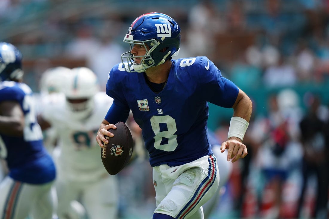 Oct 8, 2023; Miami Gardens, Florida, USA; New York Giants quarterback Daniel Jones (8) scrambles with the ball agianst the Miami Dolphins during the first half at Hard Rock Stadium. Mandatory Credit: Jasen Vinlove-USA TODAY Sports