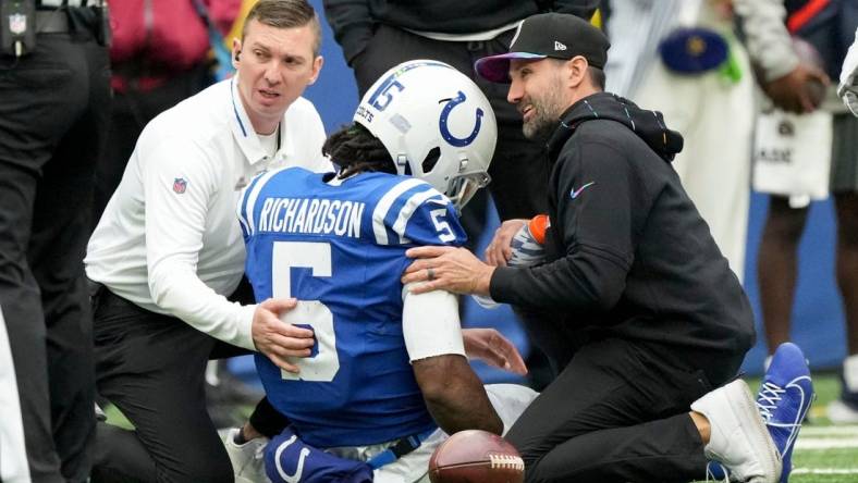 Team personnel tend to Indianapolis Colts quarterback Anthony Richardson (5) after hurting his shoulder Sunday, Oct. 8, 2023, during a game against the Tennessee Titans at Lucas Oil Stadium in Indianapolis.