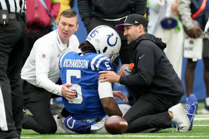 Team personnel tend to Indianapolis Colts quarterback Anthony Richardson (5) after hurting his shoulder Sunday, Oct. 8, 2023, during a game against the Tennessee Titans at Lucas Oil Stadium in Indianapolis.