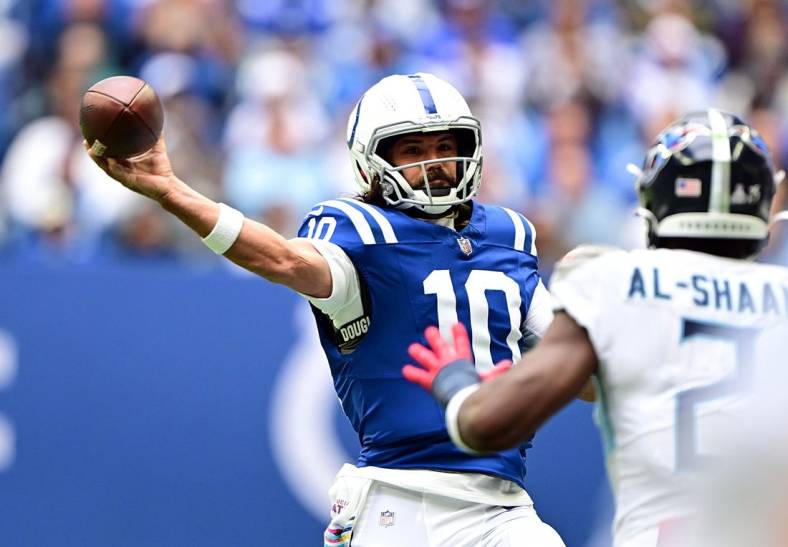 Oct 8, 2023; Indianapolis, Indiana, USA; Indianapolis Colts quarterback Gardner Minshew (10) throws a pass over Tennessee Titans linebacker Azeez Al-Shaair (2) during the second half at Lucas Oil Stadium. Mandatory Credit: Marc Lebryk-USA TODAY Sports