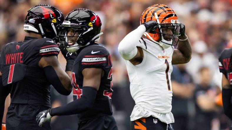 Oct 8, 2023; Glendale, Arizona, USA; Cincinnati Bengals wide receiver Ja'Marr Chase (1) flexes as he celebrates a first down against the Arizona Cardinals in the first half at State Farm Stadium. Mandatory Credit: Mark J. Rebilas-USA TODAY Sports