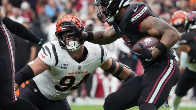 Oct 8, 2023; Glendale, Arizona, United States; Arizona Cardinals running back James Conner (6) stiff arms Cincinnati Bengals defensive end Sam Hubbard (94) at State Farm Stadium. Mandatory Credit: Joe Rondone-USA TODAY Sports