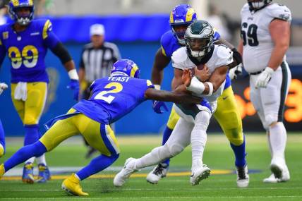 Oct 8, 2023; Inglewood, California, USA; Philadelphia Eagles quarterback Jalen Hurts (1) runs the ball against Los Angeles Rams safety Russ Yeast (2) during the first half at SoFi Stadium. Mandatory Credit: Gary A. Vasquez-USA TODAY Sports