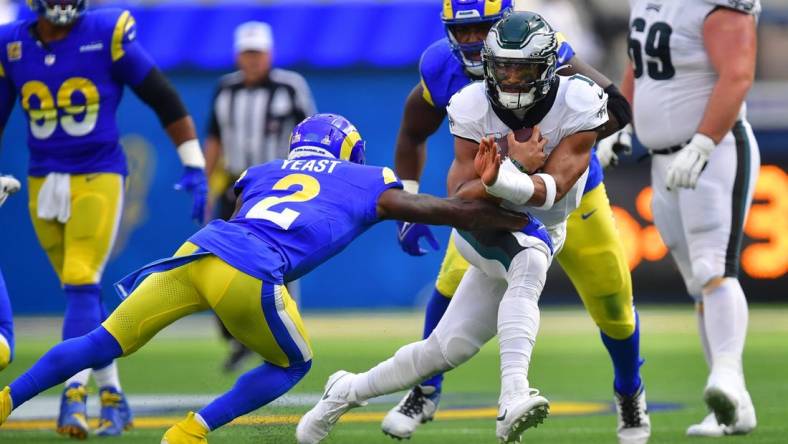 Oct 8, 2023; Inglewood, California, USA; Philadelphia Eagles quarterback Jalen Hurts (1) runs the ball against Los Angeles Rams safety Russ Yeast (2) during the first half at SoFi Stadium. Mandatory Credit: Gary A. Vasquez-USA TODAY Sports