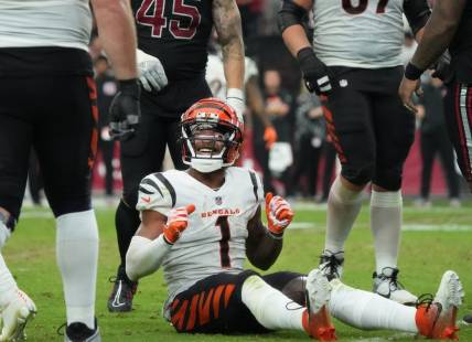 Oct 8, 2023; Glendale, Arizona, United States; Cincinnati Bengals receiver Ja'Marr Chase (1) smiles from the ground after a first down reception against the Arizona Cardinals at State Farm Stadium.