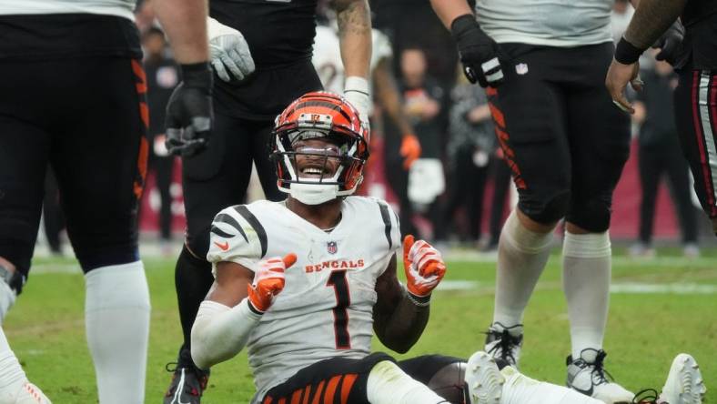 Oct 8, 2023; Glendale, Arizona, United States; Cincinnati Bengals receiver Ja'Marr Chase (1) smiles from the ground after a first down reception against the Arizona Cardinals at State Farm Stadium.