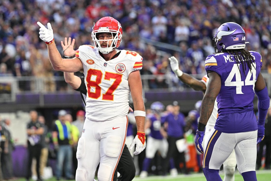 Oct 8, 2023; Minneapolis, Minnesota, USA; Kansas City Chiefs tight end Travis Kelce (87) reacts to a first down as Minnesota Vikings safety Josh Metellus (44) looks on during the third quarter at U.S. Bank Stadium. Mandatory Credit: Jeffrey Becker-USA TODAY Sports