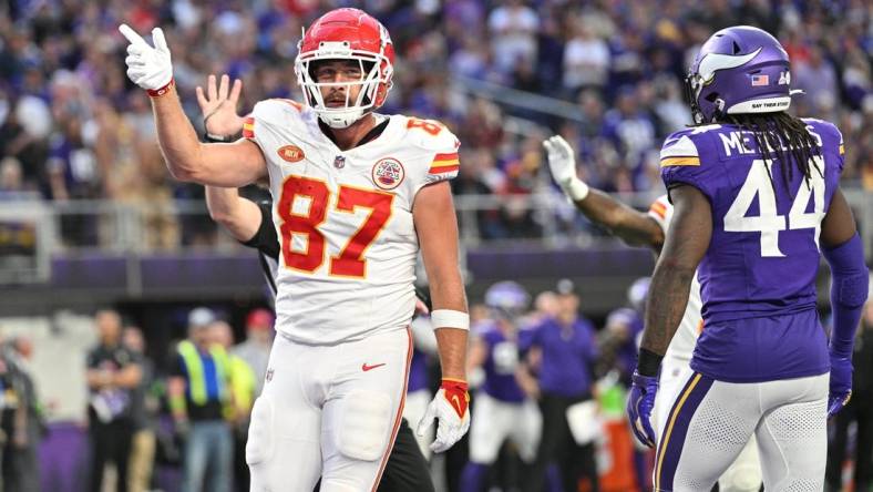 Oct 8, 2023; Minneapolis, Minnesota, USA; Kansas City Chiefs tight end Travis Kelce (87) reacts to a first down as Minnesota Vikings safety Josh Metellus (44) looks on during the third quarter at U.S. Bank Stadium. Mandatory Credit: Jeffrey Becker-USA TODAY Sports