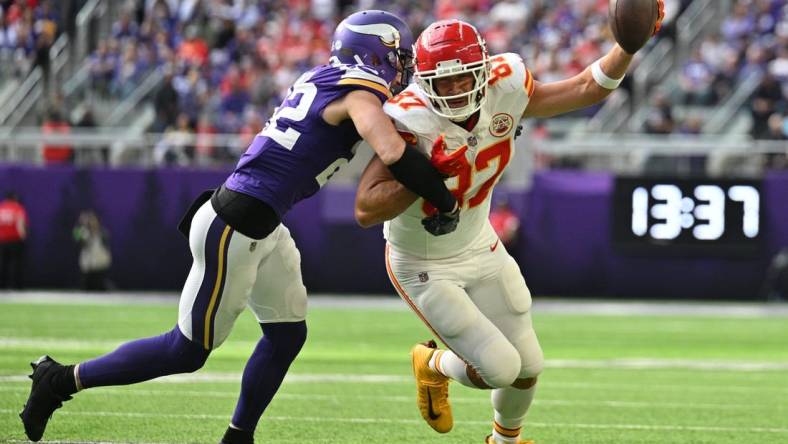 Oct 8, 2023; Minneapolis, Minnesota, USA; Kansas City Chiefs tight end Travis Kelce (87) gets yards after the catch as Minnesota Vikings safety Harrison Smith (22) makes a tackle during the second quarter at U.S. Bank Stadium. Mandatory Credit: Jeffrey Becker-USA TODAY Sports