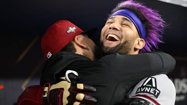 Oct 9, 2023; Los Angeles, California, USA; Arizona Diamondbacks left fielder Lourdes Gurriel Jr. (12) reacts with catcher Jose Herrera (11) after hitting a home run during the sixth inning for game two of the NLDS for the 2023 MLB playoffs at Dodger Stadium. Mandatory Credit: Jayne Kamin-Oncea-USA TODAY Sports