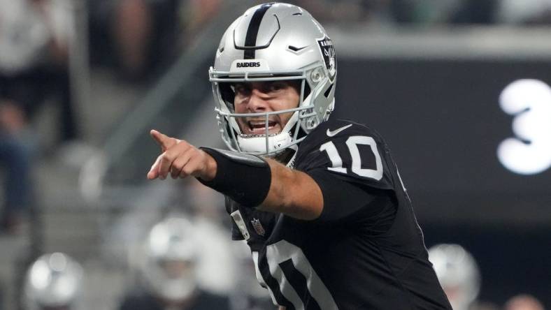 Oct 9, 2023; Paradise, Nevada, USA; Las Vegas Raiders quarterback Jimmy Garoppolo (10) throws the ball against the Green Bay Packers in the second half at Allegiant Stadium. Mandatory Credit: Kirby Lee-USA TODAY Sports