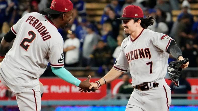 Arizona Diamondbacks shortstop Geraldo Perdomo (2) and Arizona Diamondbacks right fielder Corbin Carroll (7) celebrate their 4-2 win over the Los Angeles Dodgers during Game 2 of the NLDS at Dodger Stadium in Los Angeles on Oct. 9, 2023.