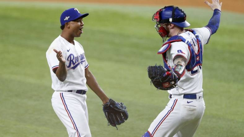 Oct 10, 2023; Arlington, Texas, USA; Texas Rangers relief pitcher Jose Leclerc (25) and catcher Jonah Heim (28) celebrate after defeating the Baltimore Orioles in game three of the ALDS for the 2023 MLB playoffs at Globe Life Field. Mandatory Credit: Andrew Dieb-USA TODAY Sports