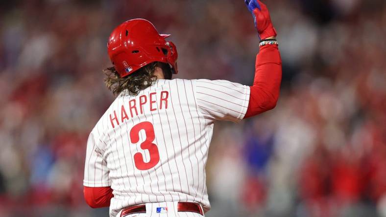 Oct 11, 2023; Philadelphia, Pennsylvania, USA; Philadelphia Phillies first baseman Bryce Harper (3) hits a solo during the fifth inning against the Atlanta Braves in game three of the NLDS for the 2023 MLB playoffs at Citizens Bank Park. Mandatory Credit: Bill Streicher-USA TODAY Sports