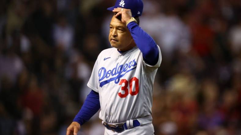 Oct 11, 2023; Phoenix, Arizona, USA; Los Angeles Dodgers manager Dave Roberts (30) reacts in the seventh inning against the Arizona Diamondbacks for game three of the NLDS for the 2023 MLB playoffs at Chase Field. Mandatory Credit: Mark J. Rebilas-USA TODAY Sports