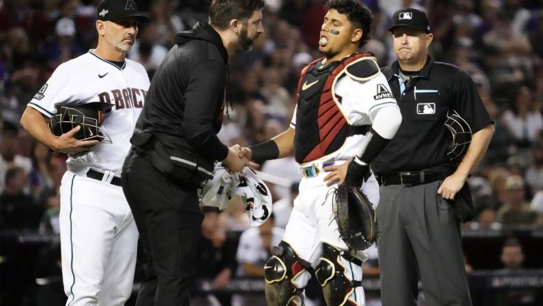 Oct 11, 2023; Phoenix, AZ, USA; Arizona Diamondbacks catcher Gabriel Moreno (14) reacts to an injury against the Los Angeles Dodgers in the fifth inning during Game 3 of the NLDS at Chase Field. Mandatory Credit: Rob Schumacher-Arizona Republic